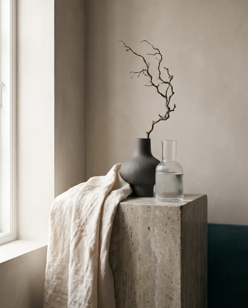 Home and living objects on a stone plinth